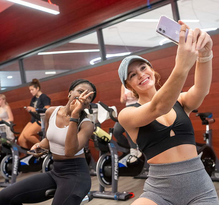 Students take a selfie in a group fitness class.