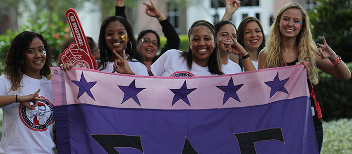 Sorority sisters holding their flag